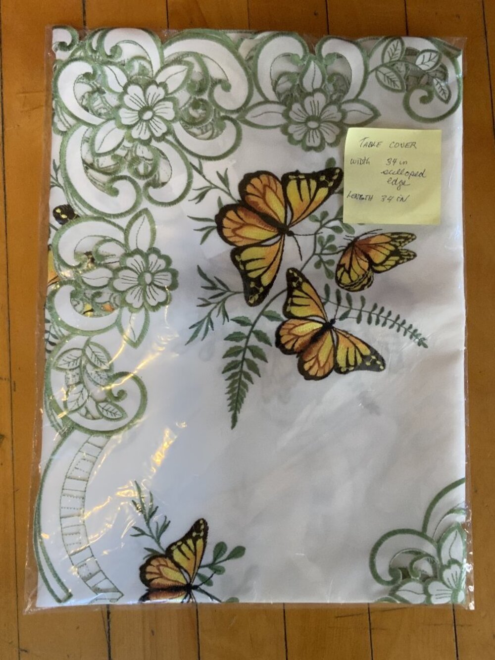 Vintage table cover that features yellow monarch butterflies, green floral embro